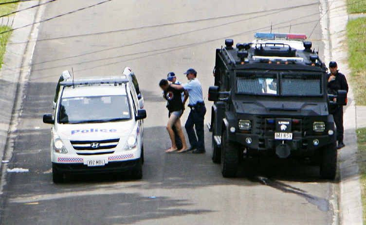 Police escort an 18-year-old man from Kanangra St, Redbank Plains, who held two women hostage for over five hours yesterday. Police escort an 18-year-old man from Kanangra St, Redbank Plains, who held two women hostage for over five hours yesterday.